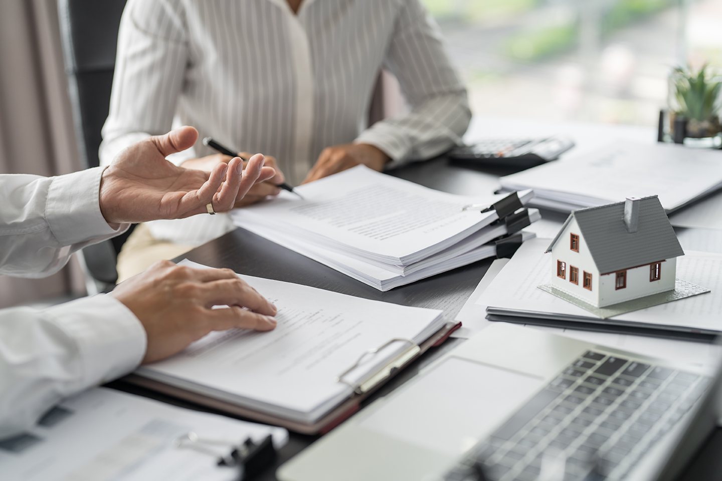 Foreign investors reviewing real estate documents and contracts to buy property in Dubai