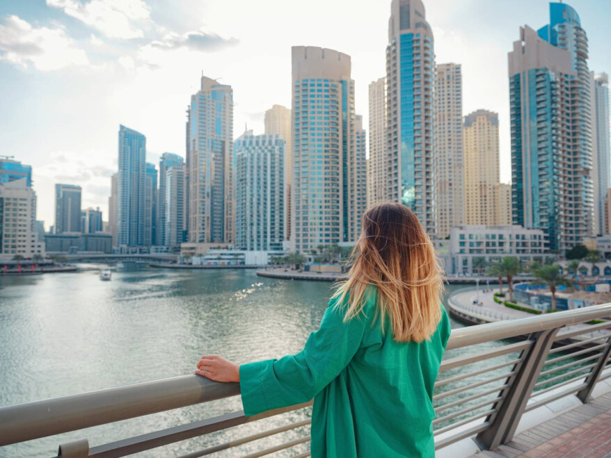 Woman overlooking Dubai Marina skyline – Golden Visa Dubai lifestyle